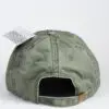 A green hat with a tag on the back of it.