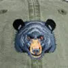 A close up of the bear 's face on a hat