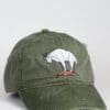A green hat with an animal on it.