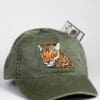 A green hat with an orange eyed leopard on it.