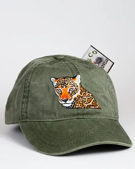 A green hat with an orange eyed leopard on it.