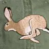 A close up of the side of a hat with a rabbit on it