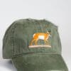 A green hat with an antelope on it.