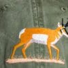 A close up of an antelope on the back of a hat