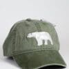 A green hat with a polar bear on it.