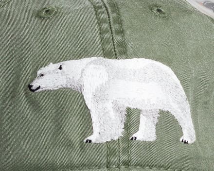 A close up of the polar bear on a hat