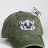 A green hat with a dollar bill sticking out of it.