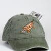 A green hat with an orange turtle on it.