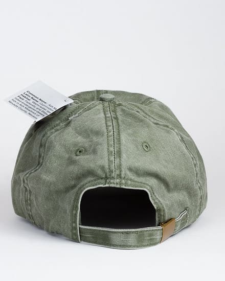 A green hat with a tag on the back of it.