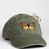 A green hat with an orange butterfly on it.
