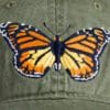 A close up of the back side of a hat with a butterfly on it
