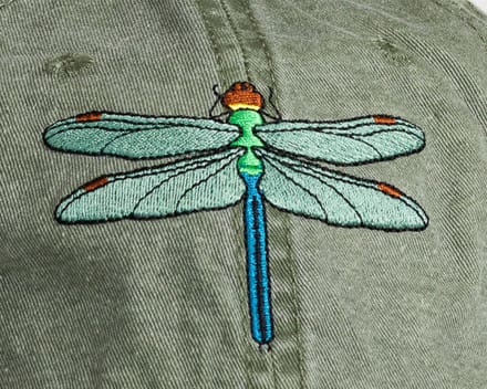 A close up of the dragonfly on the shirt