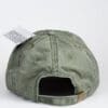 A green hat with a tag on the back of it.