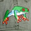 A close up of the frog on a hat
