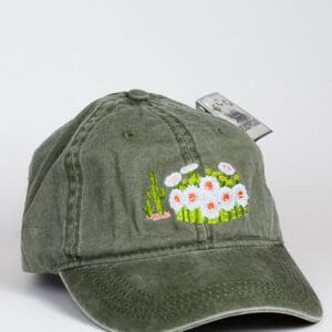 A green hat with a Saguaro Blooms Cap embroidered on it.