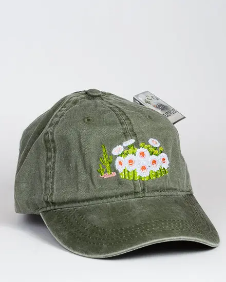 A green hat with a Saguaro Blooms Cap embroidered on it.