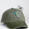 A green hat with a hummingbird on it.