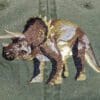A triceratops embroidered on the back of a jacket.