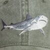 A close up of the shark on a hat