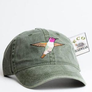 A green hat with a hummingbird on it.