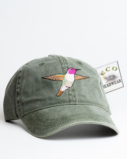 A green hat with a hummingbird on it.