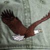 A close up of an eagle on the side of a hat