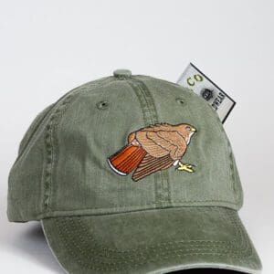 A green hat with an image of a bird on it.