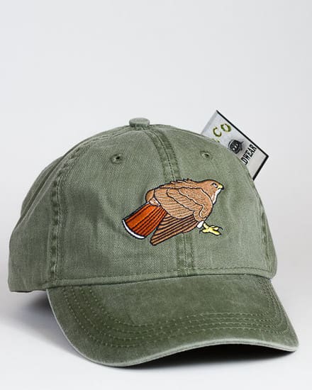 A green hat with an image of a bird on it.