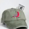 A green hat with a red bird on it