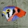 A close up of the bird 's head on a hat