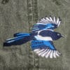 A Pileated Woodpecker Cap with a bird embroidered on it.