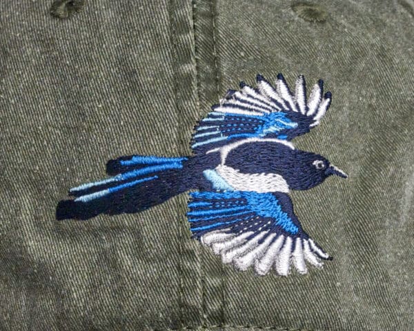 A Pileated Woodpecker Cap with a bird embroidered on it.