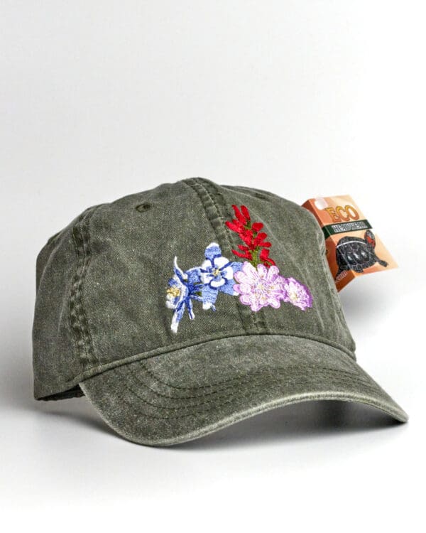 A Pileated Woodpecker Cap with a flower embroidered on it.