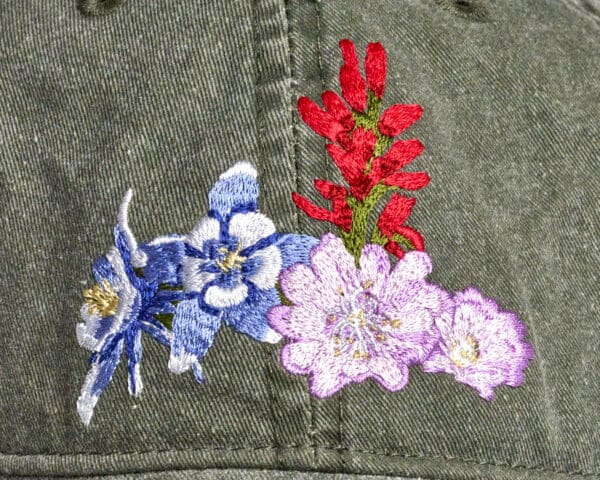A Pileated Woodpecker Cap with flowers embroidered on it.