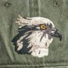 A green hat with a Pileated Woodpecker embroidered on it.