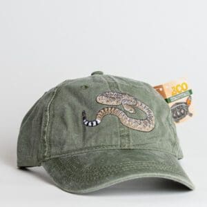 A green hat with an image of a snake on it.