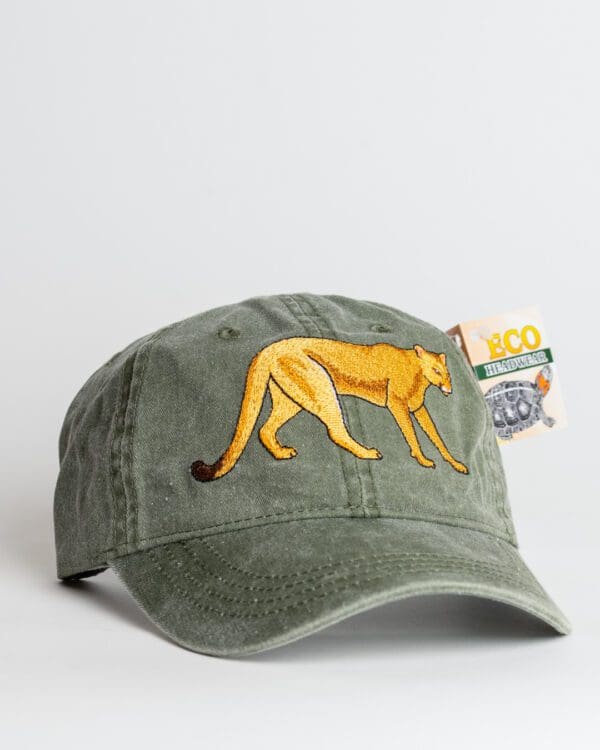 A green hat with an embroidered yellow cat on it.