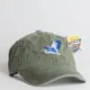 A green hat with an image of a bird on it.