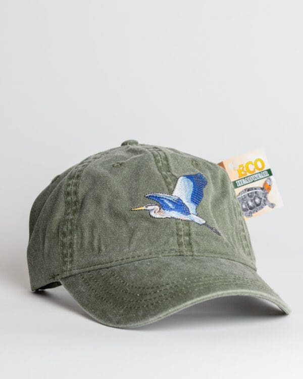 A green hat with an image of a bird on it.