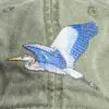 A close up of an embroidered bird on the side of a hat.