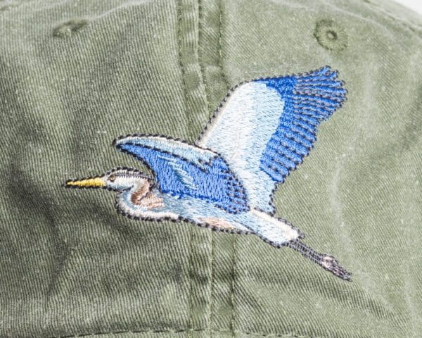 A close up of an embroidered bird on the side of a hat.