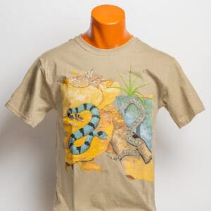 A tan t-shirt with an image of a snake and palm trees.
