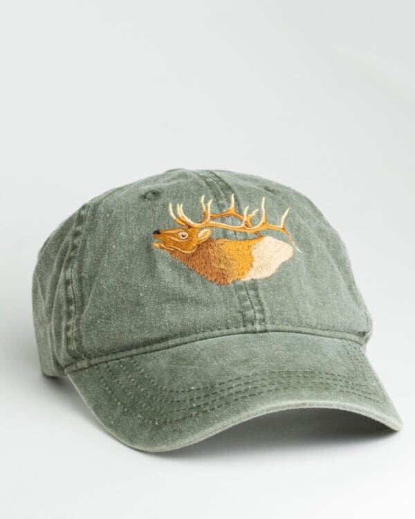A green hat with an embroidered deer head on it.