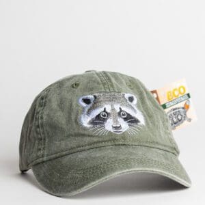 A green hat with an embroidered racoon on it.