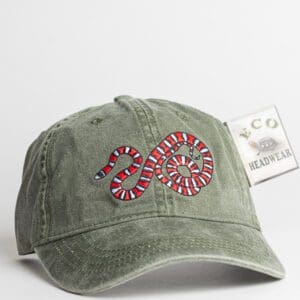 A green hat with a red and white snake on it.