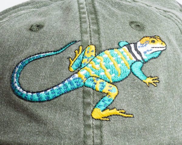 A lizard is painted on the back of a hat.