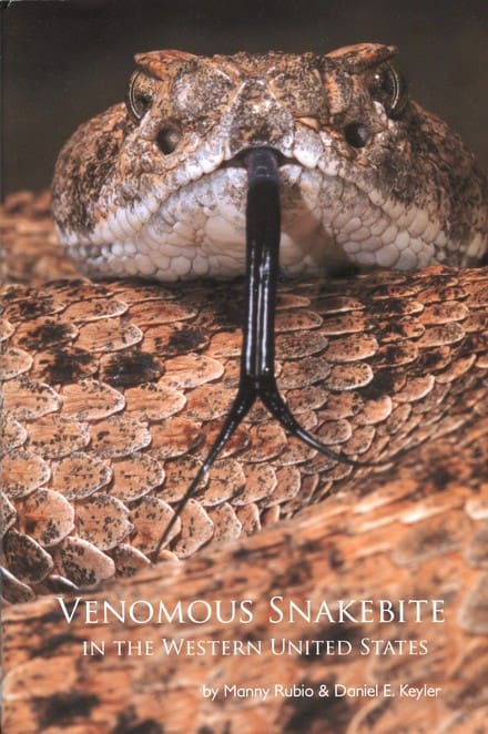 A snake with its head stuck in the middle of it's body.