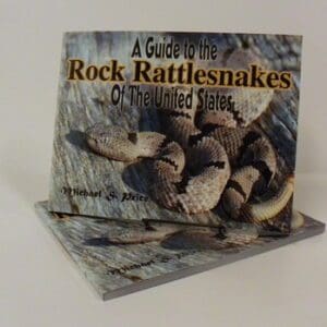 A book about rattlesnakes is shown on top of a table.