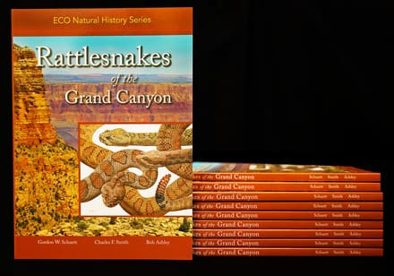 A stack of books about rattlesnakes in the grand canyon.