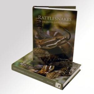 A book about rattlesnakes is shown on top of a book.